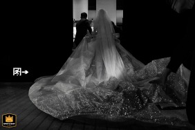 The Fujian newlyweds leave the stage at the hotel, stepping away together after the formalities as the crowd looks on and the reception celebration continues inside.